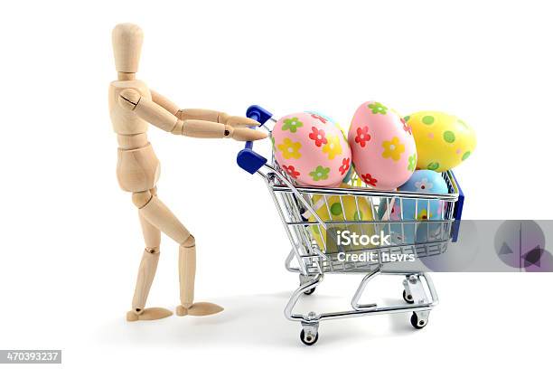 Wooden Manniquine With Shopping Cart And Easter Eggs Stock Photo - Download Image Now