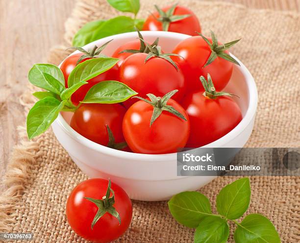 Cherry Tomatoes In A Bowl With Basil Stock Photo - Download Image Now - Basil, Bowl, Burlap