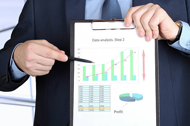 istock young businessman showing graphs by pen 470403544
