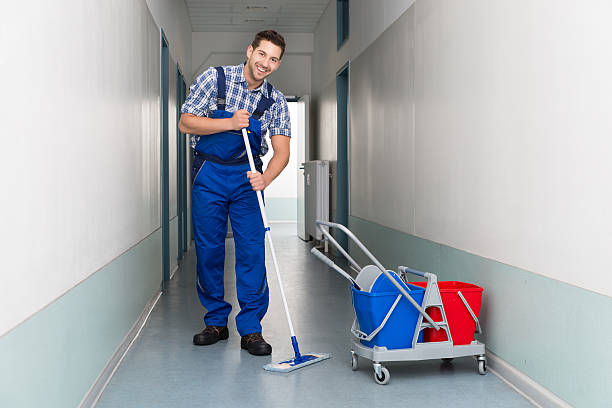 istock A happy male janitor cleaning an office hallway 470403712