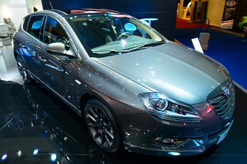 Brussels, Belgium - January 14, 2014: Lancia Delta hatchback car on display at the 2014 Brussels motor show. People in the background are looking at the cars.