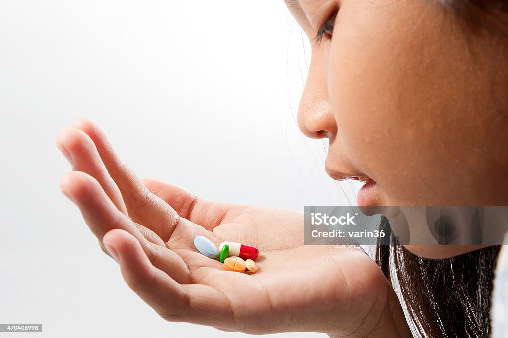 take a pill a woman takes a pill to cure 2015 Stock Photo