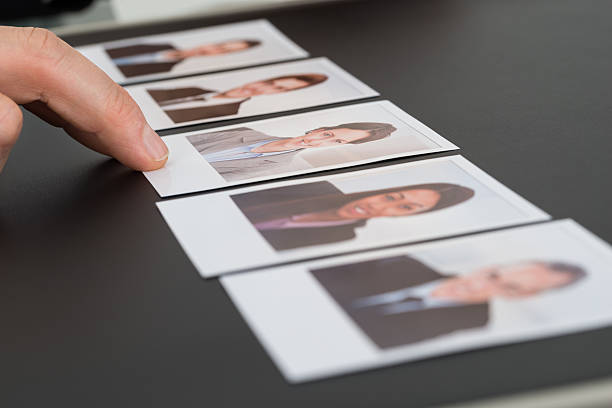 istock Person Choosing Photograph Of A Candidate 470412326