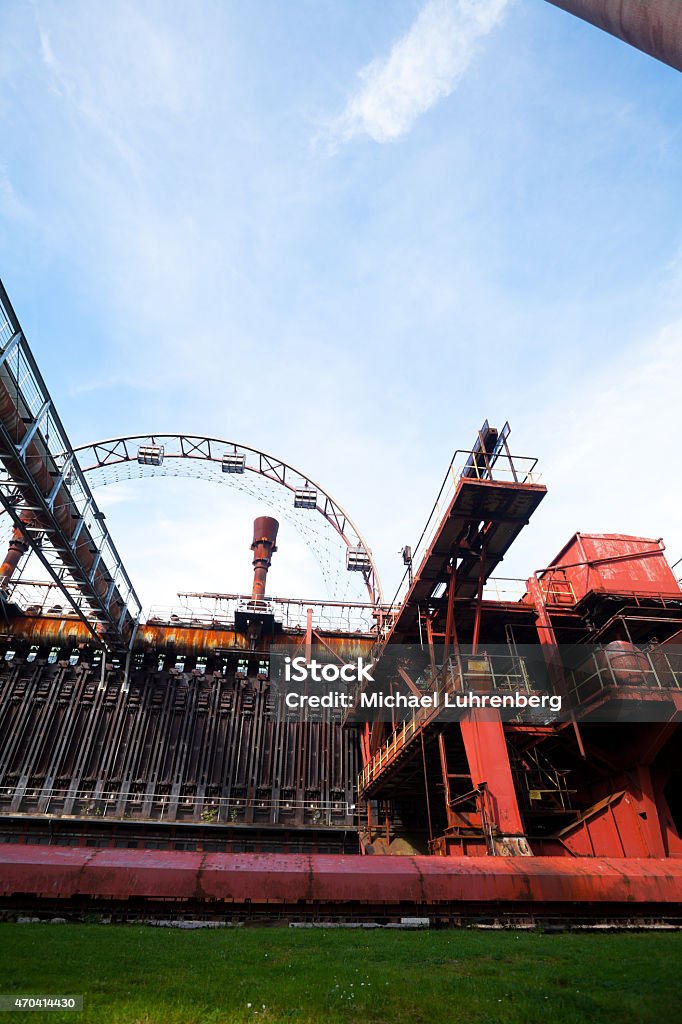 Summer shot of coke oven Zollverein and ferris wheel Summer shot with blue sky of coke oven Zeche Zollverein and part of ferris wheel in Essen, Ruhrgebiet. 2015 Stock Photo