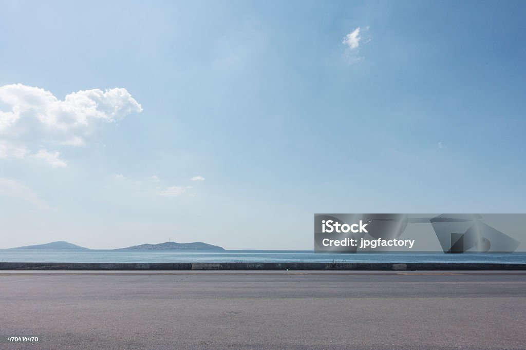 Empty asphalt lot with seaside background on a sunny day asphalt ground space with seaside background Road Stock Photo