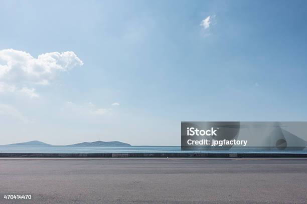 Empty Asphalt Lot With Seaside Background On A Sunny Day Stock Photo - Download Image Now