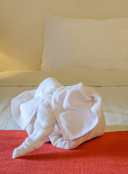 istock White towel in form of elephant on bed 470414870