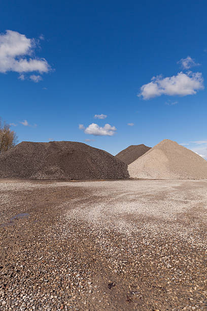 istock Piles of Gravel at Construction Site under Bright Blue Sky 470416140