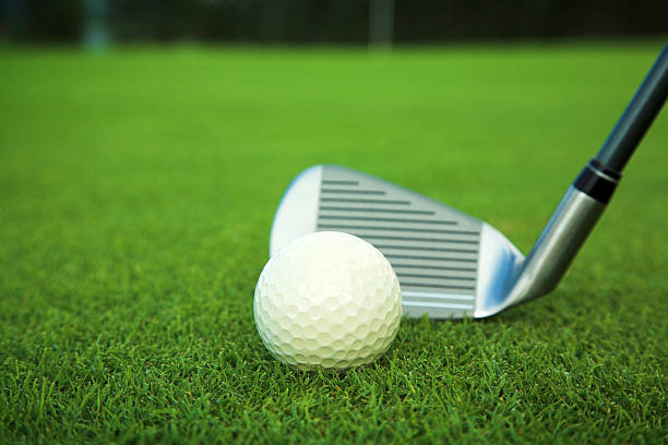 istock golf ball and stick on field close up 470419181