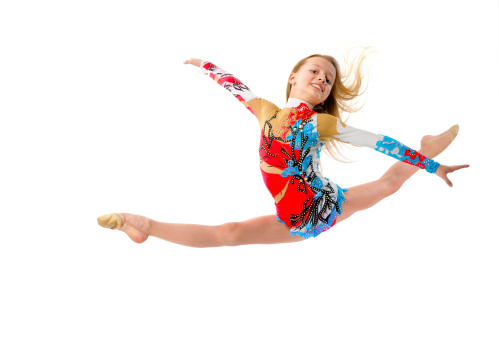 Young girl gymnast jumping isolated on white