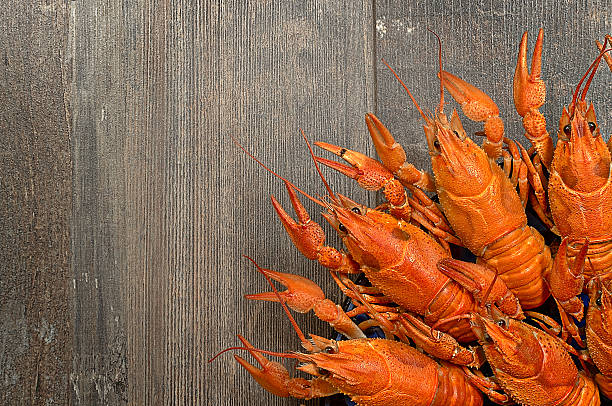 istock Plate of red crayfishes on old wooden table 470420130