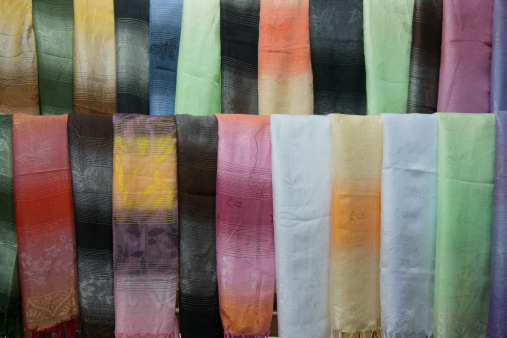 a row of woven kerchiefs on a market