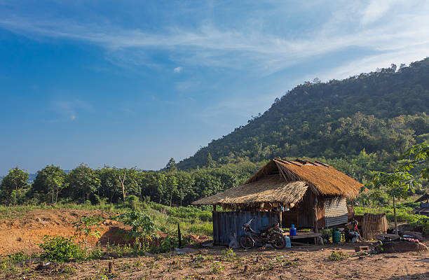 istock hut near forest and hill with blue sky 470420417