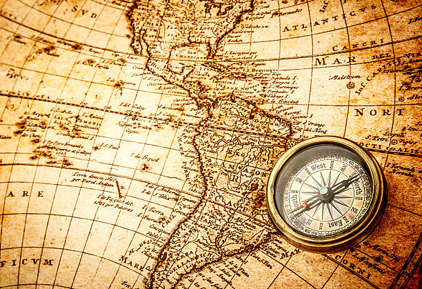 istock Vintage compass lies on an ancient world map. 470422668