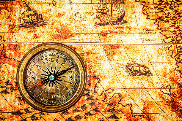 istock Vintage compass lies on an ancient world map. 470422680