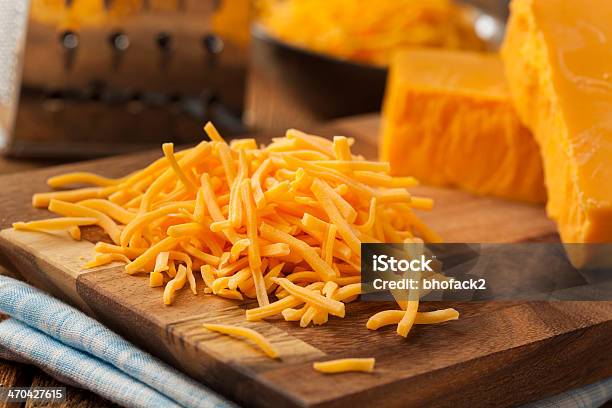 Organic Shredded Sharp Cheddar Cheese Stock Photo - Download Image Now - Shredded, Cheddar Cheese, Cheese