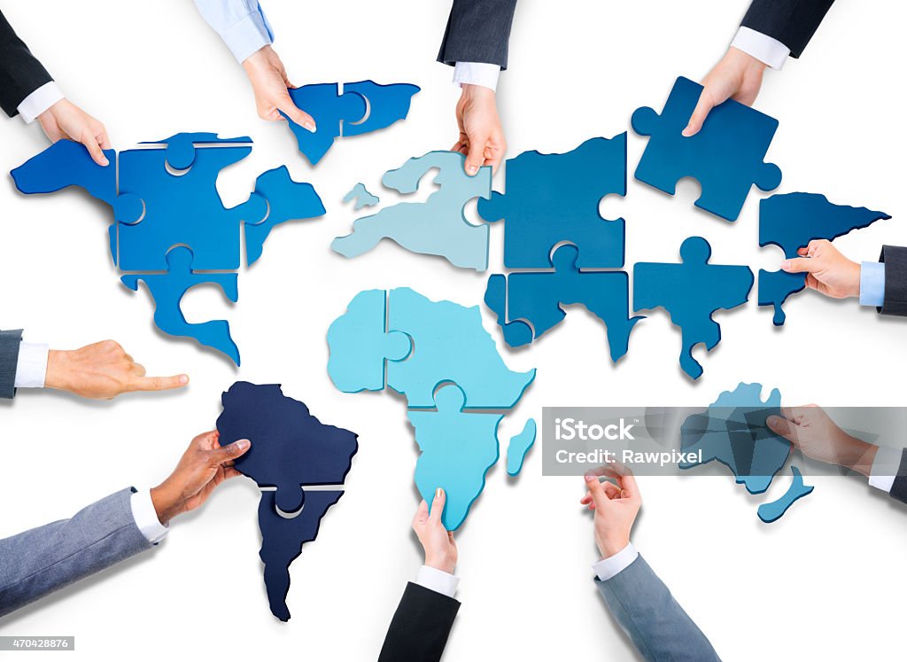 Hands holding out the fitted pieces of a world map puzzle Group of Business People with Jigsaw Puzzle Forming in World Map***NOTE TO INSPECTOR: Source of reference map: http://earthobservatory.nasa.gov/Features/BlueMarble/BlueMarble_monthlies.php Illustration was created on the 29th of March, 2013 using illustrator and Photoshop. 1 layer of data was used for the outline of the world map.*** Puzzle Stock Photo