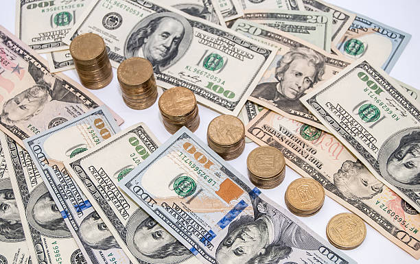 istock price graph coins and US dollar bills background 470429354