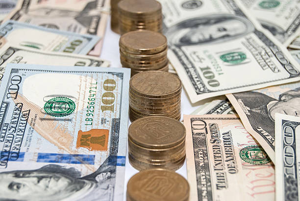 istock price graph coins and US dollar bills background 470429358