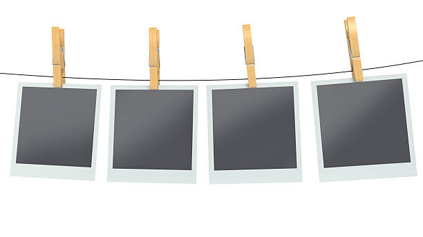 istock blank photos on clothesline, isolated white background 470430192