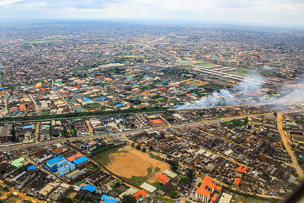 Aerial View of Lagos, Nigeria As seen from a plane, the aerial view of Lagos, Nigeria looks like a patchwork quilt of colored roofs, sand, grass and streets.  lagos nigeria stock pictures, royalty-free photos & images