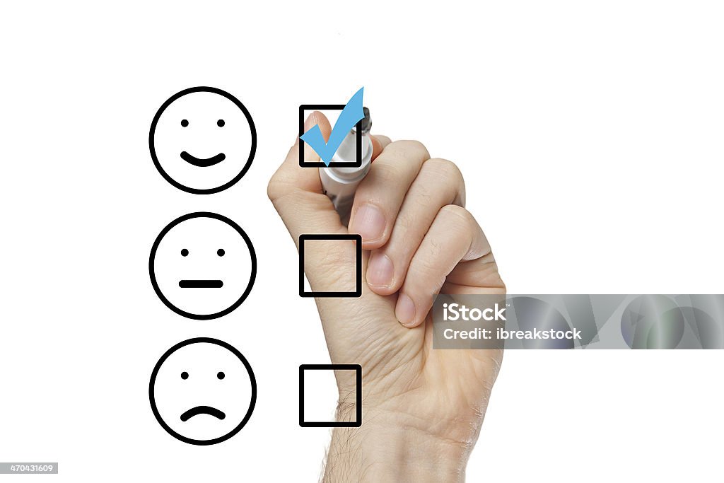 Hand putting check mark with blue marker Hand putting check mark with blue marker on customer service evaluation form Business Stock Photo