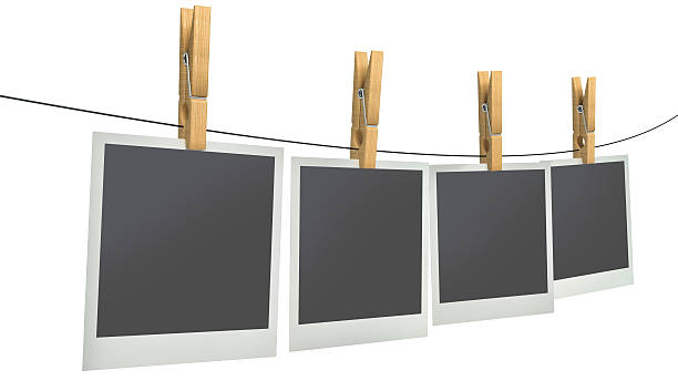 istock blank photos on clothesline, isolated white background 470432834