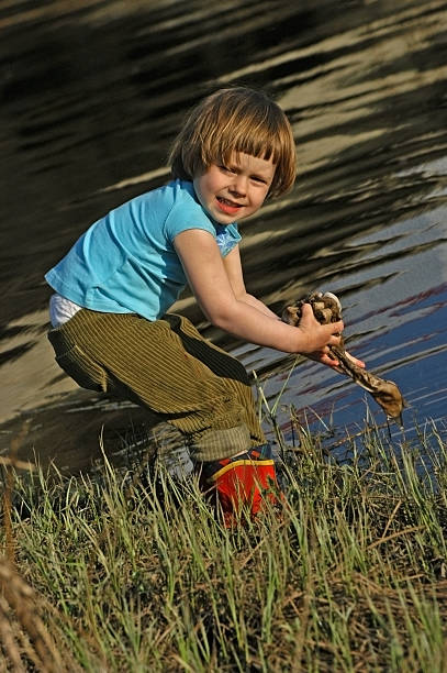 istock Three year old girl washes her clothes 470432843