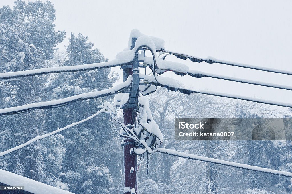 Electric pole to endure The telegraph pole in a snow day. Power Line Stock Photo