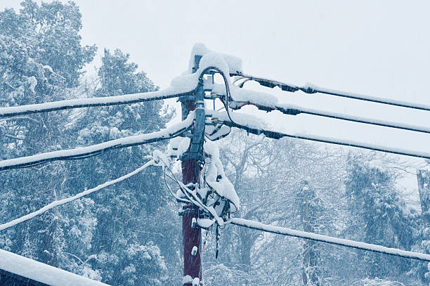 Electric pole to endure The telegraph pole in a snow day. power cable photos stock pictures, royalty-free photos & images
