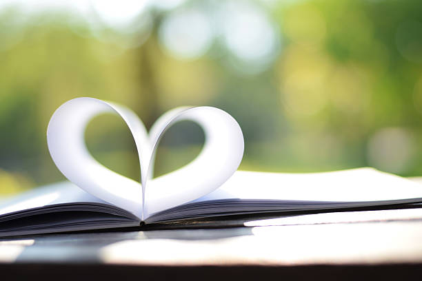 istock close up heart shape from paper book (vintage background) 470435454