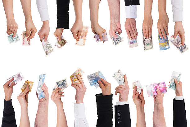 istock lot of hands with important currencies 470436046