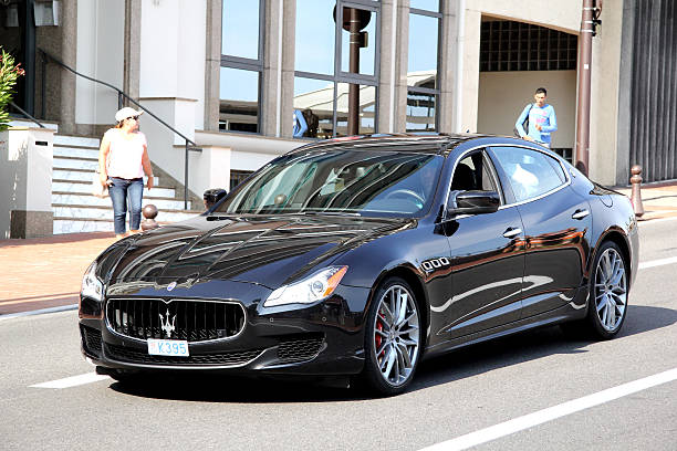 Monte Carlo, Monaco - August 2, 2014: Black luxury sedan Maserati Quattroporte drives at the city street.