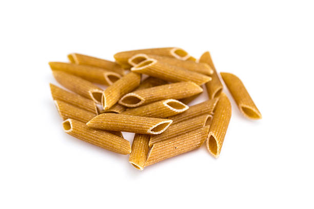 pasta integrale-maccheroni isolato su sfondo bianco - pasta whole wheat spaghetti raw foto e immagini stock