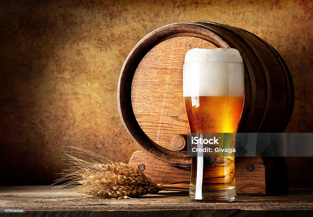 Wooden barrel and beer Wooden barrel and beer with wheat on a wooden table Beer - Alcohol Stock Photo