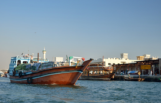 Dubai, United Arab Emirates - January 21, 2015: Wooden ships in Dubai Creek between Deira and Bur Dubai. 