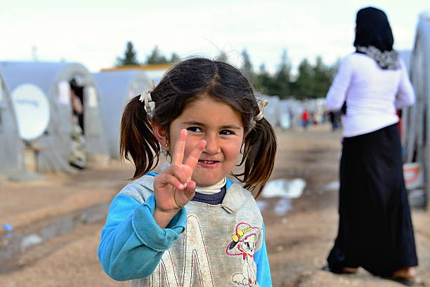 people in refugee camp stock photo