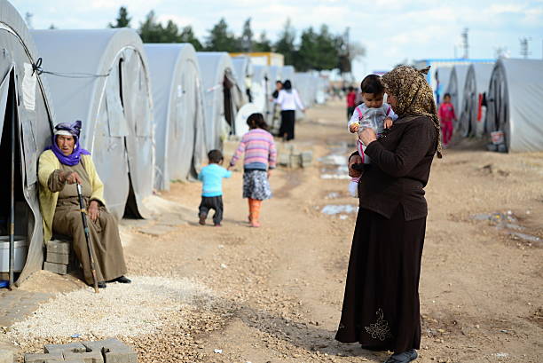 people in refugee camp Suruc, Turkey - April 3, 2015: Syrian people in refugee camp in Suruc. These people are refugees from Kobane and escaped because of Islamic state attack. international border photos stock pictures, royalty-free photos & images