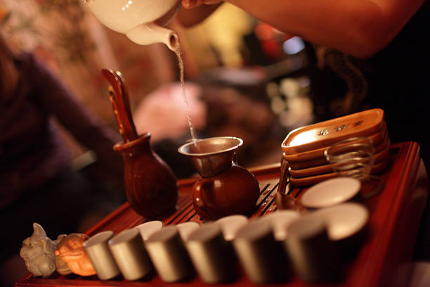 istock Woman pouring tea from teapot 470438311