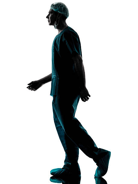 istock doctor surgeon man walking silhouette 470439899