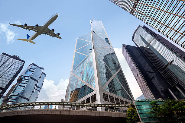 istock Tall city buildings and a plane flying overhead 470440108