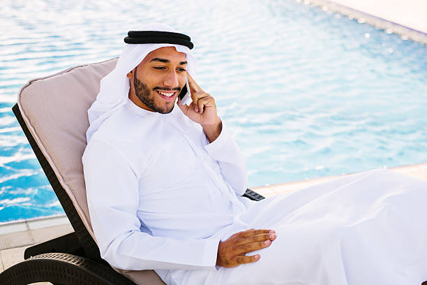 Arab man relaxing by the pool