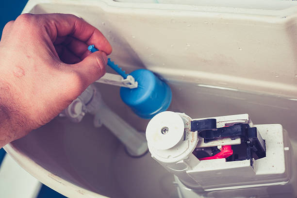 istock A man fixing the toilet so it will flush 470446983