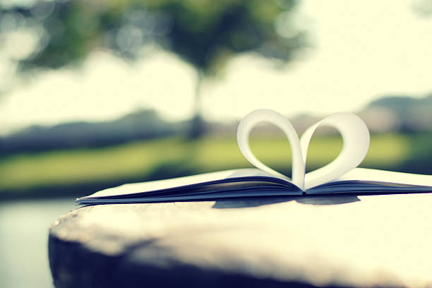 istock close up heart shape from paper book (vintage background) 470448030