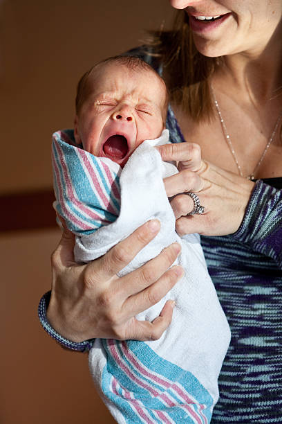 istock Mother Holding One Day Old Yawning Baby 470448804
