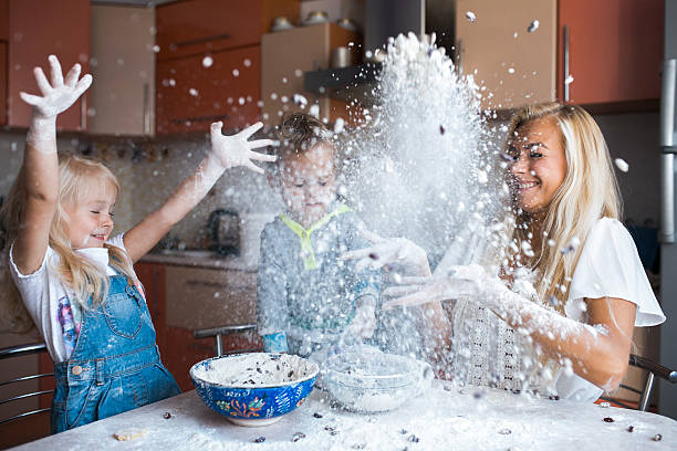 Mather with kids at kitchen stock photo
