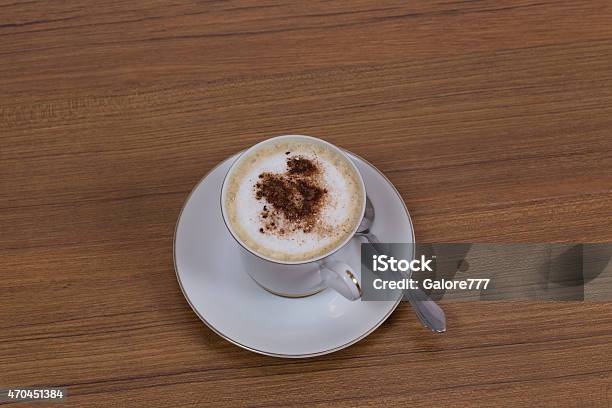 Cuppaccino In A Cup On Brown Woodgrain Background Stock Photo - Download Image Now - 2015, Affectionate, Beige