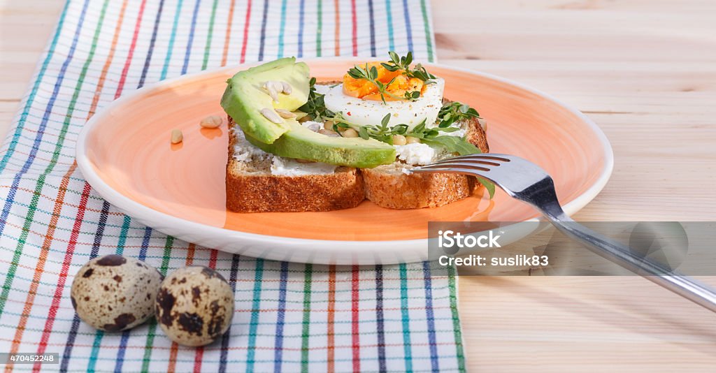 sandwiches with eggs sandwiches with eggs and avocado on orange plate and chekered fabric 2015 Stock Photo