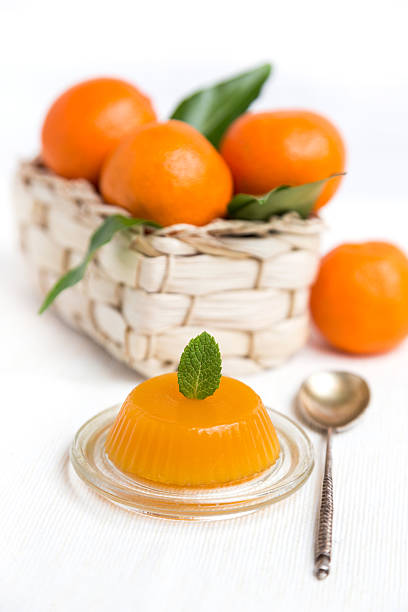 istock jelly and fresh orange mandarins with leafs in basket 470452703