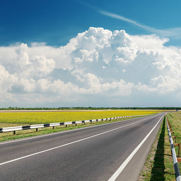 istock asphalt road goes to cloudy horizon 470453627